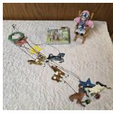 One - Horse windchime/mobile, One-bag of Cocktail napkins, One-bisque porcelain doll featuring a matte, realistic finish on its head, hands, and feet, and soft cloth body seated in a wooden rocking ch