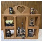 Vintage wood wall hanging shelf featuring a decorative heart cutout and die-cast metal collectibles. Cello, wagon, scale, slot machine, grandfather clock, stove which are pencil sharpeners and a cream
