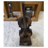 Vintage wood wall hanging shelf featuring a decorative heart cutout and die-cast metal collectibles. Cello, wagon, scale, slot machine, grandfather clock, stove which are pencil sharpeners and a cream
