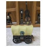 Vintage wood wall hanging shelf featuring a decorative heart cutout and die-cast metal collectibles. Cello, wagon, scale, slot machine, grandfather clock, stove which are pencil sharpeners and a cream