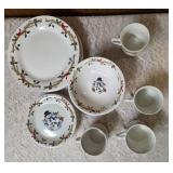 Four piece setting of Home Essentials Woodland Celebration dinnerware set.  Featuring snowman and holly branch patterns.