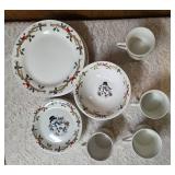 Four piece setting of Home Essentials Woodland Celebration dinnerware set.  Featuring snowman and holly branch patterns.