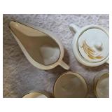Vintage Homer Laughlin Golden Wheat set that includes a sugar bowl and creamer bowl and eight coffee cups. This set  likely produced in the 1950