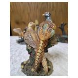 Three -Vintage Resin Figurines and 1 Pheasant on  Wagon Wheel Plate Holder.