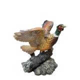 Three -Vintage Resin Figurines and 1 Pheasant on  Wagon Wheel Plate Holder.