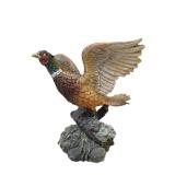 Three -Vintage Resin Figurines and 1 Pheasant on  Wagon Wheel Plate Holder.
