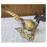 Three -Vintage Resin Figurines and 1 Pheasant on  Wagon Wheel Plate Holder.
