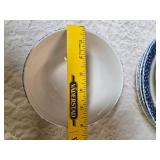 Vintage dinnerware set with 4 place settings is made by Thomson Pottery .  This set  is "Snowman Winterland Blue Sponge". Each place setting includes a dinner plate, salad plate, bowl and a mug.