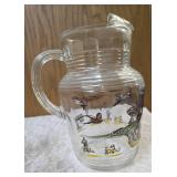 Hazel-Atlas Pitcher and  8  glasses featuring the "Pheasants" pattern. The pitcher is clear, ribbed glass with transferware illustrations of colorful flying pheasants, hunters and dogs.