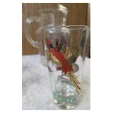 Hazel-Atlas Pitcher and  8  glasses featuring the "Pheasants" pattern. The pitcher is clear, ribbed glass with transferware illustrations of colorful flying pheasants, hunters and dogs.