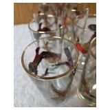 Hazel-Atlas Ice bucket and  8 glasses.   The glasses and Ice Bucket feature a 22K gold aim and detailed red, black and gold pheasant designs.