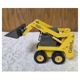 1/25 scale diecast model of a Gehl 4835 skid loader. The brand is Joal and the Manufacturer is Die-Cast Promotions (DCP) or NZG.
