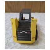 1/25 scale diecast model of a Gehl 4835 skid loader. The brand is Joal and the Manufacturer is Die-Cast Promotions (DCP) or NZG.