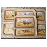 Seven vintage TV dinner trays or snack trays, likely manufactured in the 1950