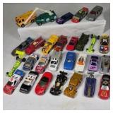 Mixed die cast cars including race cars, police vehicles, trucks, and dragsters. Various colors, styles, and themes with Hot Wheels and Matchbox type models.