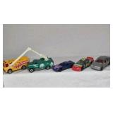 Mixed die cast cars including race cars, police vehicles, trucks, and dragsters. Various colors, styles, and themes with Hot Wheels and Matchbox type models.