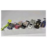 Mixed die cast cars including race cars, police vehicles, trucks, and dragsters. Various colors, styles, and themes with Hot Wheels and Matchbox type models.