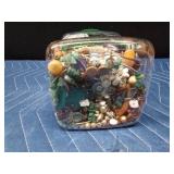 Jar of jewelry and jewelry pieces