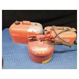 2 metal gas cans and 1 Yamaha boat gas tank