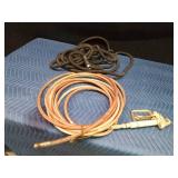 Paint sprayer hose with nozzle and a garden hose
