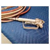 Paint sprayer hose with nozzle and a garden hose
