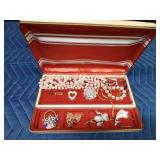 Jewel box of pins, necklaces and earrings