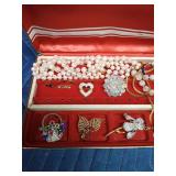Jewel box of pins, necklaces and earrings