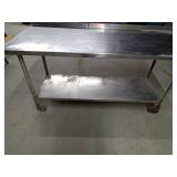 Stainless steel shop table on wheels with bottom shelf