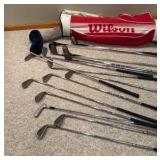 set of Spalding golf clubs and a Wilson golf bag