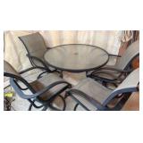 Glass top patio set with four chairs