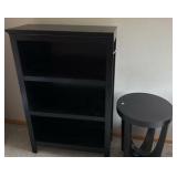 Black solid bookcase and round table