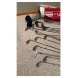 set of Spalding golf clubs and a Wilson golf bag