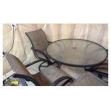 Glass top patio set with four chairs