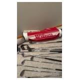 set of Spalding golf clubs and a Wilson golf bag