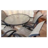 Glass top patio set with four chairs