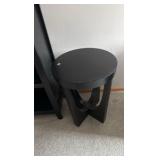 Black solid bookcase and round table