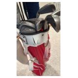 set of Spalding golf clubs and a Wilson golf bag