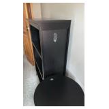 Black solid bookcase and round table