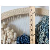 Handwoven Circular Yarn Wall Hanging with Pom-Pom Accents and Two Ornate Round Wall Plaques