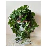 Variegated Faux Pothos Plant in Wicker Basket on Black Metal Plant Stand