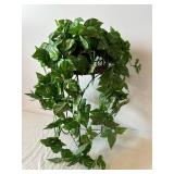 Variegated Faux Pothos Plant in Wicker Basket on Black Metal Plant Stand