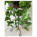 Variegated Faux Pothos Plant in Wicker Basket on Black Metal Plant Stand