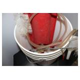 Red Plastic Fluid Pump with Clear Tubing and Cleaning Brush in Bucket