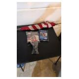 Three flags and flag holder. two flags are still in the bag