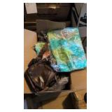 box of shoulder bags and tie-dye t-shirts
