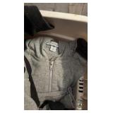 One container of various zip up hoodies and container of towels