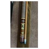 two pool sticks in cases