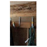 lots of garden hoses and Wall hangers