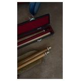 two pool sticks in cases