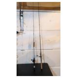 two fishing poles one still has a tag